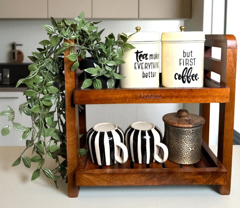 "- Premium Mango Wood – Made from solid mango wood, offering durability, natural strength, and long-lasting quality - Two-Tier Design – Maximizes vertical space, providing ample storage for spices, jars, condiments, or small kitchen essentials - Multi-Purpose Organizer – Ideal for kitchen counters, study desks, bathrooms, or bedside tables to keep everyday items neatly arranged - Rustic & Modern Appeal – Natural wood grains and handcrafted finish add elegance that suits both contemporary and traditional spaces -Sturdy & Functional – Strong construction ensures stability and can hold multiple jars or items without wobbling -Easy to Maintain – Smooth finish, easy to wipe clean, and resistant to everyday wear"