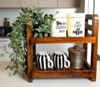 "- Premium Mango Wood – Made from solid mango wood, offering durability, natural strength, and long-lasting quality - Two-Tier Design – Maximizes vertical space, providing ample storage for spices, jars, condiments, or small kitchen essentials - Multi-Purpose Organizer – Ideal for kitchen counters, study desks, bathrooms, or bedside tables to keep everyday items neatly arranged - Rustic & Modern Appeal – Natural wood grains and handcrafted finish add elegance that suits both contemporary and traditional spaces -Sturdy & Functional – Strong construction ensures stability and can hold multiple jars or items without wobbling -Easy to Maintain – Smooth finish, easy to wipe clean, and resistant to everyday wear"