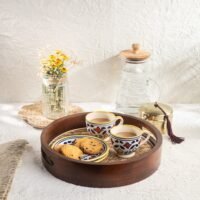 "- Premium Mango Wood with Cane Inlay – Handcrafted from seasoned mango wood, featuring a woven cane mat base for a natural textured look - Two Elegant Finishes – Available in Walnut and Natural wood tones, designed to complement a variety of home décor styles - Versatile Serving Tray – Ideal for serving tea, coffee, snacks, cocktails, or for styling candles, flowers, or books as a decorative centerpiece - Modern Round Design – Sleek 12-inch circular shape blends rustic warmth with contemporary elegance - Durable & Eco-Friendly – Made from 100% natural, food-safe mango wood and cane; sustainable, non-toxic, and built to last.