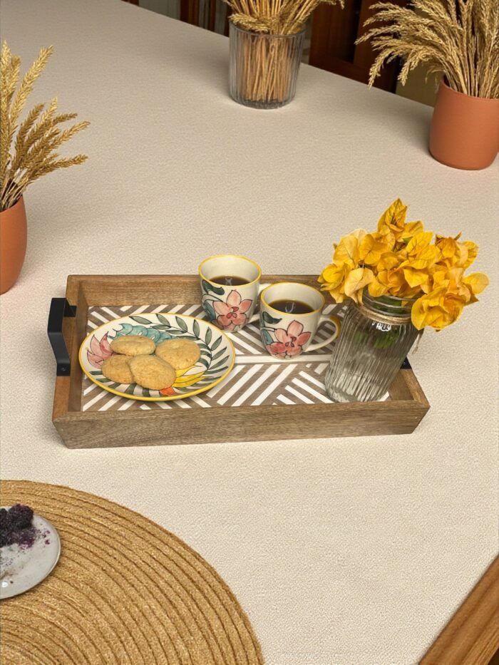 "- Premium Mango Wood with Cane Inlay – Handcrafted from seasoned mango wood, featuring a woven cane mat base for a natural, textured look - Artisan Handcrafted Detailing – Each tray is carefully made by skilled artisans, blending organic cane with durable wood for timeless elegance - Elegant Rectangular Design – Spacious 40 cm tray ideal for serving tea, coffee, snacks, or cocktails, and for styling as a decorative centerpiece - Durable & Eco-Friendly – Made from 100% natural, food-safe materials that are sustainable, non-toxic, and built to last - Perfect for Gifting – A thoughtful, versatile gift for housewarmings, weddings, festive occasions, or anyone who loves handcrafted home essentials"