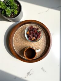 "- Premium Mango Wood with Cane Inlay – Handcrafted from seasoned mango wood, featuring a woven cane mat base for a natural textured look - Two Elegant Finishes – Available in Walnut and Natural wood tones, designed to complement a variety of home décor styles - Versatile Serving Tray – Ideal for serving tea, coffee, snacks, cocktails, or for styling candles, flowers, or books as a decorative centerpiece - Modern Round Design – Sleek 12-inch circular shape blends rustic warmth with contemporary elegance - Durable & Eco-Friendly – Made from 100% natural, food-safe mango wood and cane; sustainable, non-toxic, and built to last"