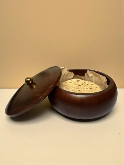 "- Premium Mango Wood – Handcrafted from seasoned mango wood with a polished finish, offering durability and a rich natural grain - Natural Heat Retention – Dense wood construction keeps rotis, chapatis, and tortillas warm and fresh for longer - Secure Wooden Lid with Knob – Ergonomic lid ensures freshness while providing an easy grip for serving - Multi-Purpose Storage – Ideal for rotis, parathas, tortillas, bread, or as a serving bowl for snacks and dry foods