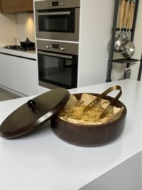 "- Premium Mango Wood – Handcrafted from seasoned mango wood with a polished finish, offering durability and a rich natural grain - Natural Heat Retention – Dense wood construction keeps rotis, chapatis, and tortillas warm and fresh for longer - Secure Wooden Lid with Knob – Ergonomic lid ensures freshness while providing an easy grip for serving - Multi-Purpose Storage – Ideal for rotis, parathas, tortillas, bread, or as a serving bowl for snacks and dry foods
